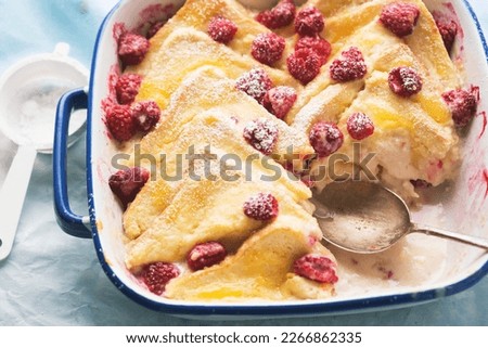 Bread and butter pudding with lemon curd, vanilla custard and raspberries 