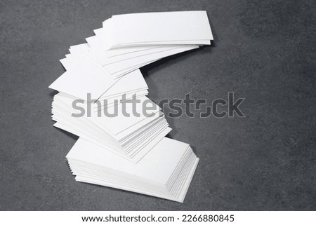 Blank white mock-up business cards on dark backgound table