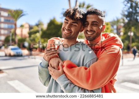 Two man couple hugging each other standing at street Royalty-Free Stock Photo #2266885481