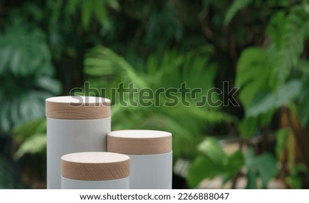 Minimal podium tabletop outdoors blur green monstera tropical forest plant background.Beauty cosmetic healthy natural product placement pedestal stand display,spring or summer jungle paradise concept.