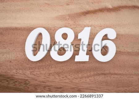 White number 0816 on a brown and light brown wooden background.