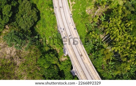 Aerial view of the old railway bridge in the tropical mountains. Beautiful tropical wallpapers for tourism and advertising. Asian landscape, drone photo