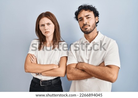 Young couple wearing casual clothes standing together skeptic and nervous, disapproving expression on face with crossed arms. negative person.  Royalty-Free Stock Photo #2266894045