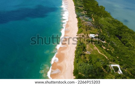 Aerial view of the long sandy tropical ocean shore. Beautiful tropical wallpapers for tourism and advertising. Asian landscape, drone photo