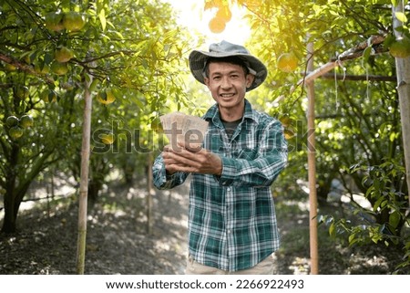 male farmer holding money from the sale agricultural products
