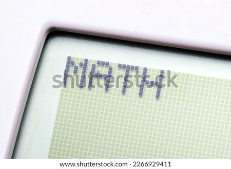 A single word MATH on a graphing calculator digital display, object macro, detail, extreme closeup, nobody. Mathematics, computer science and technology education abstract concept, learning maths Royalty-Free Stock Photo #2266929411