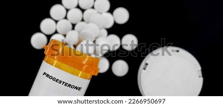 Progesterone Rx medical pills in plactic Bottle with tablets. Pills spilling out from yellow container. Royalty-Free Stock Photo #2266950697