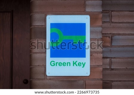 Pärnu, Estonia - February 24, 2023: Green Key certificate sign on hotel wall. Green Key is a voluntary eco-label certified to hotels and other establishments in the world.