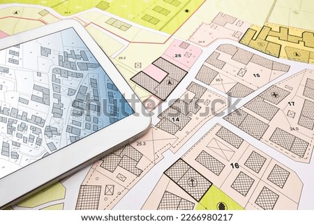 Buildings Permit concept with imaginary cadastral on digital tablet - building activity and construction industry with General Urban Plan Royalty-Free Stock Photo #2266980217