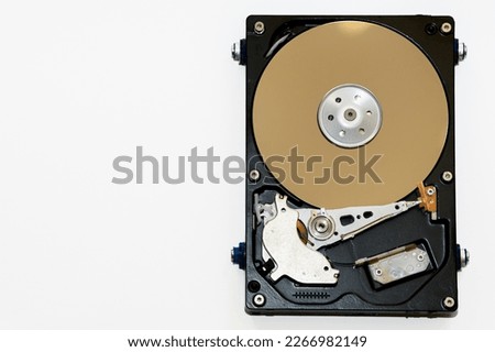 Disassembled hard drive on a white background, isolated. The electronic insides of the information storage device, the reading head. Royalty-Free Stock Photo #2266982149