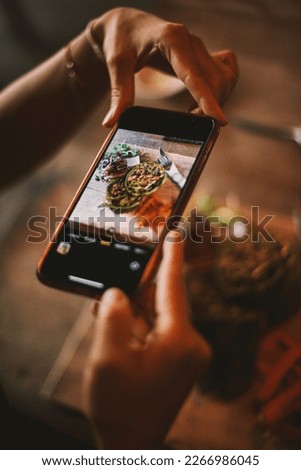 Hands snapping, holding healthy food with mobile phone Hand taking photo of healthy food with smartphone. Woman using smartphone make digital picture on screen of diet