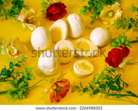 Happy Easter. Easter picture with handmade eggs on a yellow background with flowers. A holiday card. Baking in the form of Easter eggs is an interesting alternative to Easter cake. Religious holiday