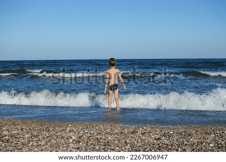 child playing running jumping on the ocean