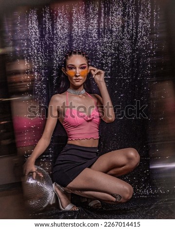 euphoria inspired editorial photo shoot glitter background purple black model caucasian hispanic model fashion photo shoot party dance disco queen ball glasses hairstyle 90s 20s hbo Royalty-Free Stock Photo #2267014415