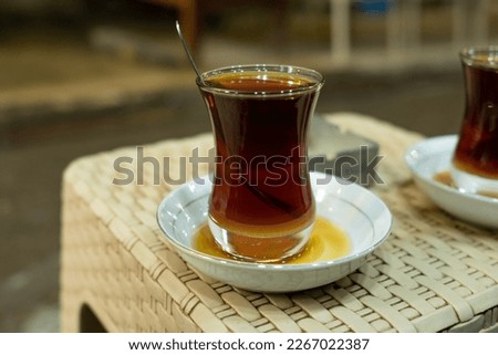 photo of eastern glass cup of tea in iraqi cafe