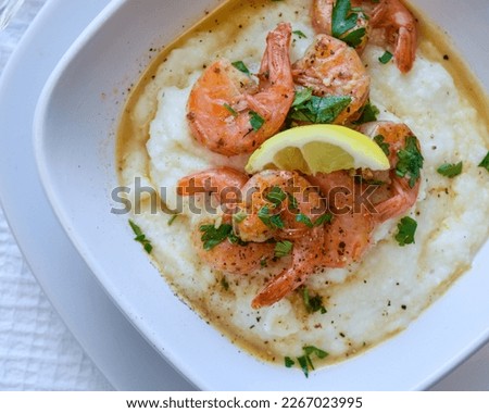 Rich flavors of the South creamy, buttery grits succulent shrimp and a flavorful broth. South Carolina style Southern hospitality, Southern food, nola food, New Orleans, Cajun Royalty-Free Stock Photo #2267023995