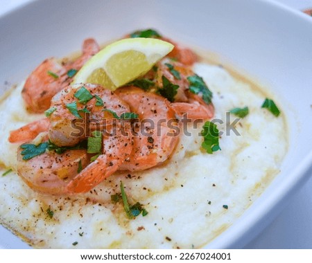 Rich flavors of the South creamy, buttery grits succulent shrimp and a flavorful broth. South Carolina style Southern hospitality, Southern food, nola food, New Orleans, Cajun Royalty-Free Stock Photo #2267024001