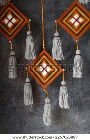 Bringing traditional Thai patterns to make a decorative hanging.