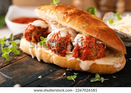 Meatball sub sandwich with marinara and mozzarella and fresh herbs Royalty-Free Stock Photo #2267026181