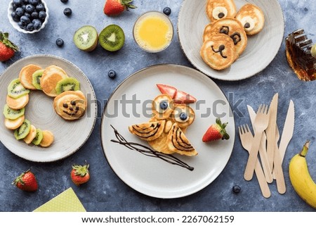 Critter pancake shapes served with fresh fruit, juice and maple syrup.