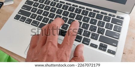 closeup photo of hands typing on a laptop keyboard