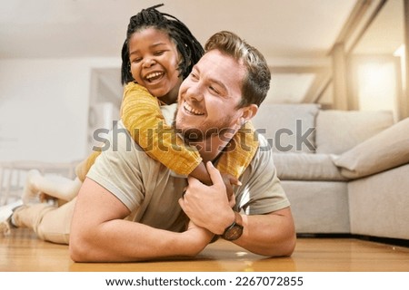 Family, children and fun with a foster father and girl having fun together on the living room floor of their home together. Love, smile and happy with a man and adopted daughter bonding in a house Royalty-Free Stock Photo #2267072855