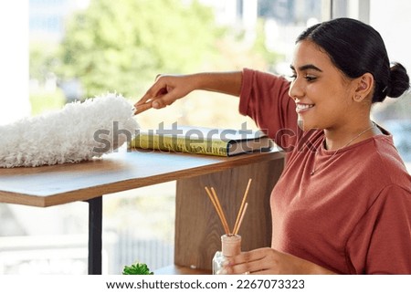 Cleaner, cleaning service and woman with dust brush, cleaning living room with housekeeping, clean furniture from dirt and hygiene. Disinfection, dusting and house work with spring cleaning. Royalty-Free Stock Photo #2267073323