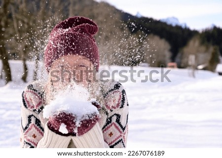 Active and Adventurous: Adult Woman Playing in the Snow During Daytime