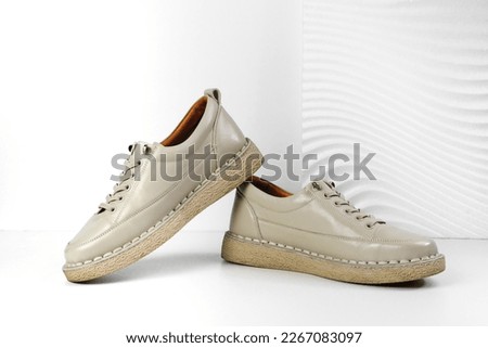 Beige Trendy Sneakers. Fashion shoes still life. Stylish photo boots in the studio.  casual shoes, fashion, footwear, shoe concept, retro, back to school. 