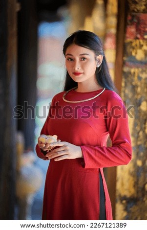 Ho Chi Minh city, Viet Nam: Vietnamese girl going to pagoda in ao dai Royalty-Free Stock Photo #2267121389