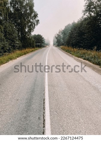 Empty asphalt road in mist near Dunika