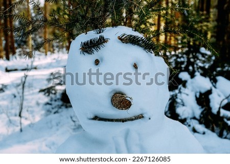 A snowman with a shy smile