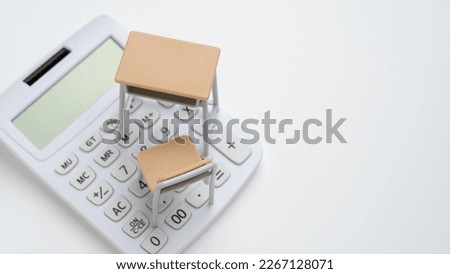 School desk and calculator. Image of tuition fees. Royalty-Free Stock Photo #2267128071