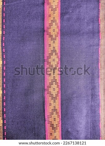 The pattern of woven sarongs is typical of art from Indonesian culture
