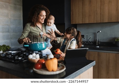 Hispanic mother and child daughter cooking at kitchen in Mexico Latin America