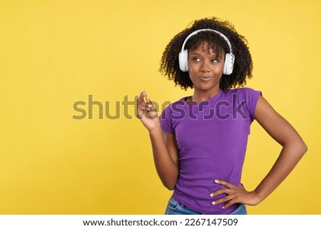 Cool beauty woman with afro hair listening to music