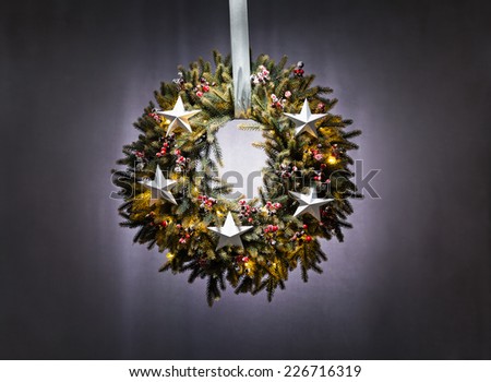 Advent wreath over silver grey background with stars