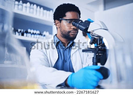 Microscope, science and black man working on study in laboratory for medical research analysis. Scientist, microbiology and biotechnology worker check investigation, innovation and dna pathology test Royalty-Free Stock Photo #2267181627