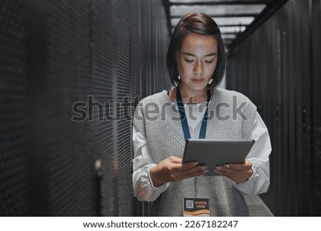 Tablet, server room and cloud computing with a programmer asian woman at work on a mainframe. Software, database and information technology with a female coder working alone on a cyber network Royalty-Free Stock Photo #2267182247