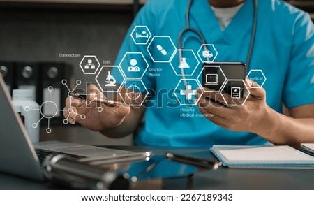 Medical technology concept. Doctor working with mobile phone and stethoscope and digital tablet laptop in modern office at hospital. Royalty-Free Stock Photo #2267189343
