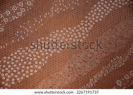 Katagami is traditional Japanese craft of making paper stencils for dyeing for example kimono textiles. Layers of thin washi paper are bonded with a glue extracted from persimmon. Beautiful artworks. Royalty-Free Stock Photo #2267191737