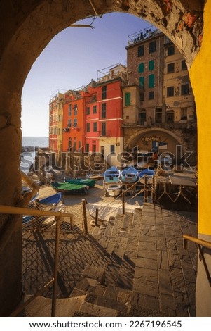 View from under an arch of boats in the fishing village of Riomaggiore. Cinque Terre National Park, Liguria region, Italy, Europe. Royalty-Free Stock Photo #2267196545