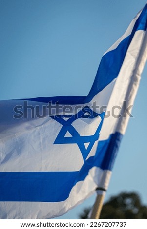 Isolated close up Israeli flag blowing in the wind.