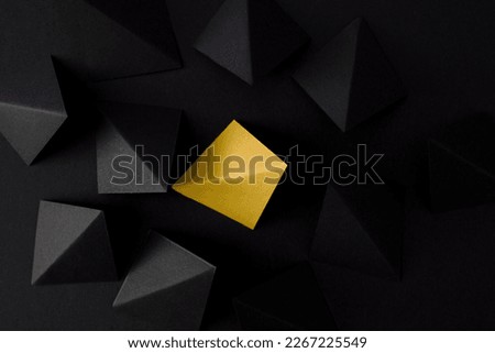 Think out of the box, be different concept. Yellow and black geometric shapes on black background