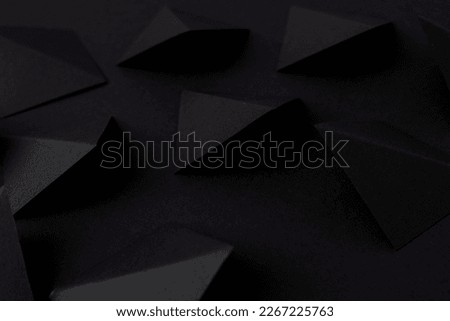 Black geometric shapes on black background
