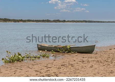 A canoe moored on the river bank.