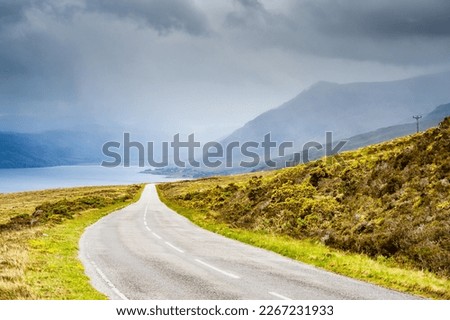 Famous road in the north-west of Scotland in dramatic brittish weather and with rain in the background