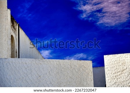 Abstract minimalistic view of blue sky over vacation homes with cubist architecture in Tunisia