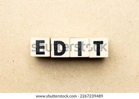 Alphabet letter block in word edit on wood background