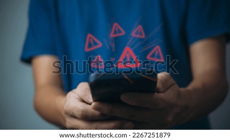 Businessman programmer, developer using smartphone with triangle caution warning sign for notification error and maintenance concept.